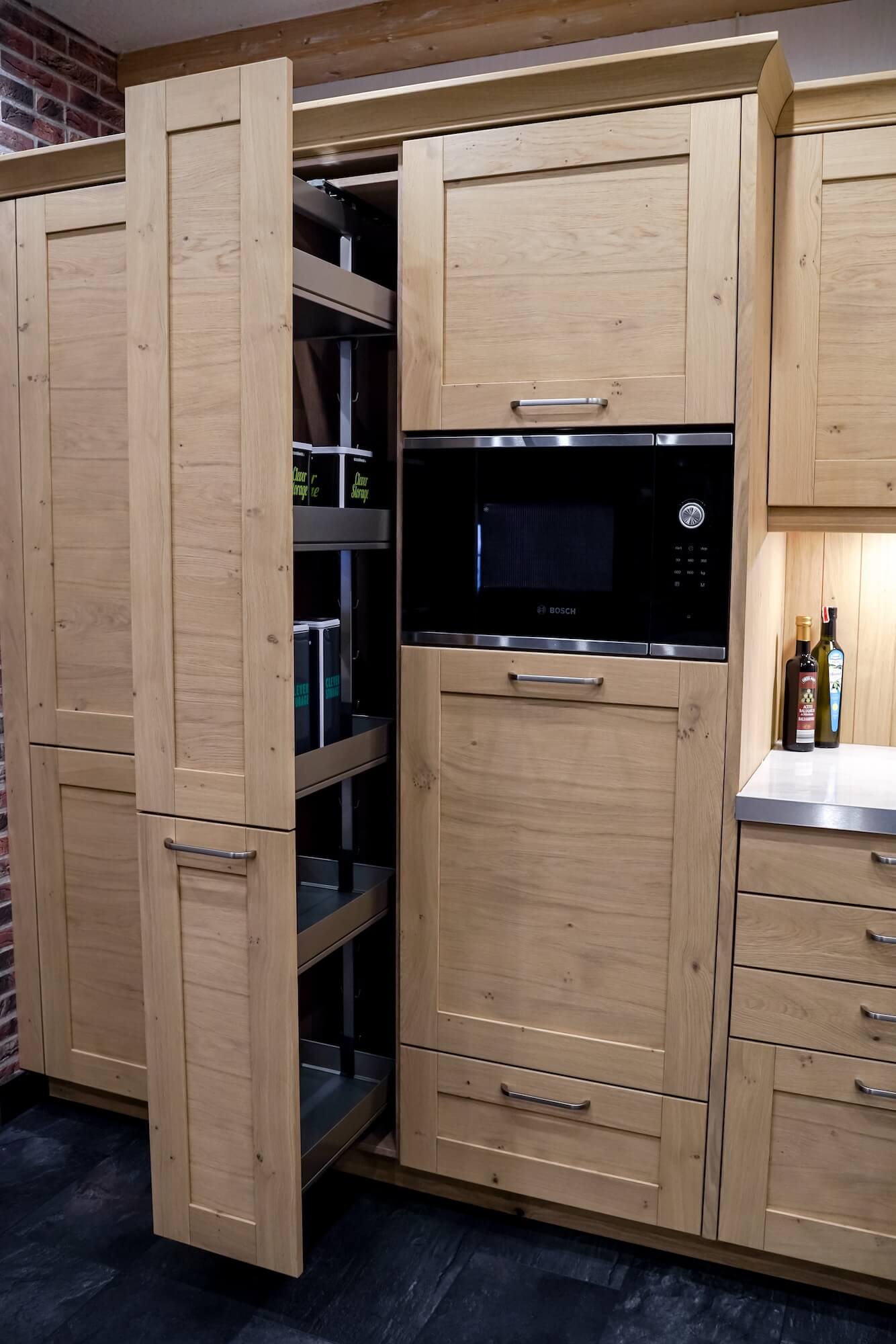 Apothekerschrank und Hochschrank in einer Landhausküche aus Holz bei Huber Küchen